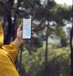 Istanbul, Turkey - January 25, 2019: Woman in the farm planning a route using a Google Maps application on Apple iPhone X. Google Maps is a most popular web mapping service for mobile provided by Google inc.