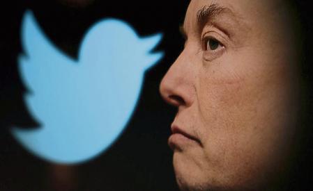 FILE PHOTO: Twitter logo and a photo of Elon Musk are displayed through magnifier in this illustration taken October 27, 2022. REUTERS/Dado Ruvic/Illustration/File Photo