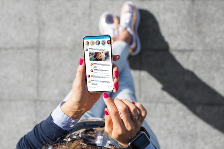 Woman using social media microblogging app on her phone